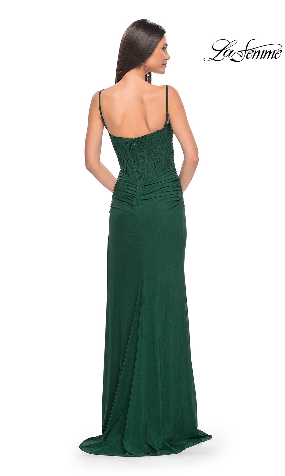 Woman wearing a fitted, floor-length dark green La Femme Ruched-Bodice Long Tight Prom Dress 32161 with thin straps, seen from the back against a white background.
